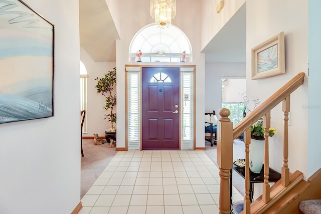 2712 Rolling Broak Dr, Orlando, FL 32837 - carpeted entrance foyer featuring baseboards, a high ceiling, a notable chandelier, and stairway