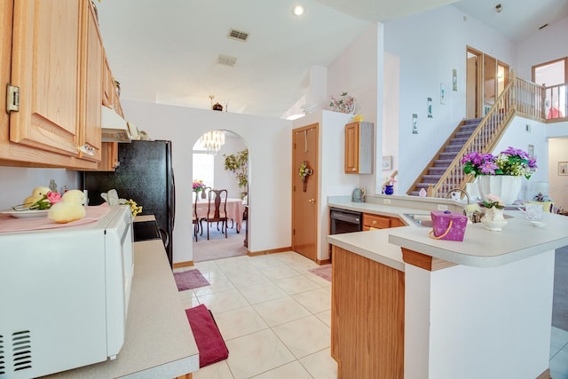 2712 Rolling Broak Dr, Orlando, FL 32837 - kitchen with light tile patterned flooring, white microwave, light countertops, under cabinet range hood, and a sink