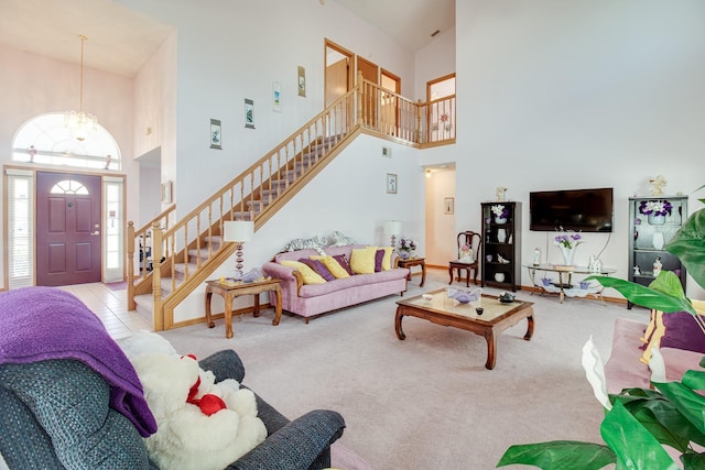 2712 Rolling Broak Dr, Orlando, FL 32837 - carpeted living area with visible vents, a towering ceiling, a notable chandelier, and stairway