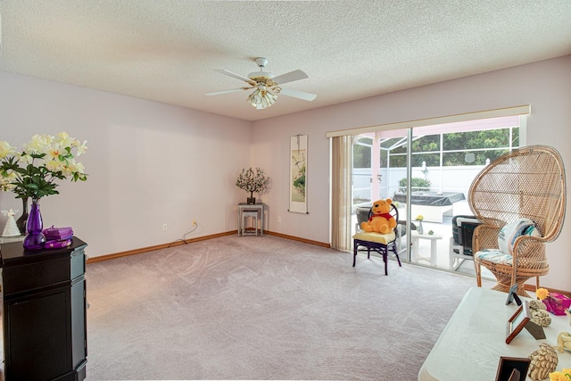 2712 Rolling Broak Dr, Orlando, FL 32837 - living area featuring baseboards, ceiling fan, light carpet, and a textured ceiling
