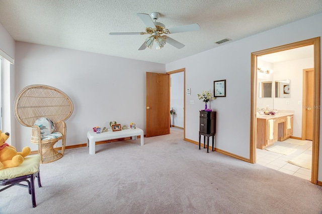 2712 Rolling Broak Dr, Orlando, FL 32837 - sitting room with visible vents, baseboards, ceiling fan, light colored carpet, and a textured ceiling