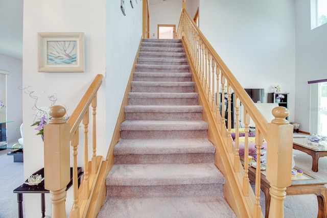 2712 Rolling Broak Dr, Orlando, FL 32837 - stairway featuring a high ceiling and carpet
