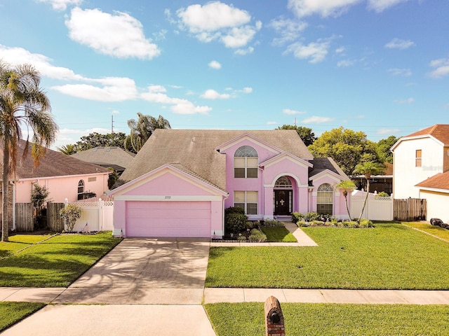 2712 Rolling Broak Dr, Orlando, FL 32837 - traditional home featuring a garage, fence, driveway, and a front lawn