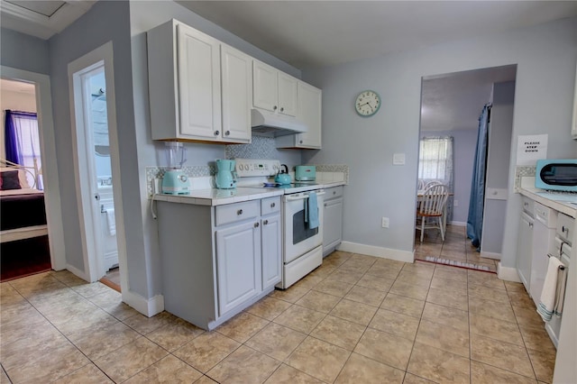 kitchen featuring light tile patterned floors, tile counters, under cabinet range hood, and white appliances