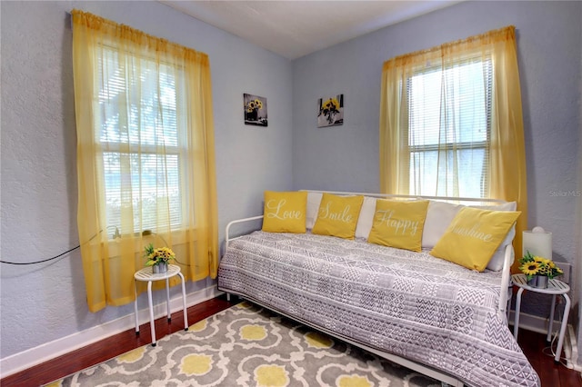 bedroom featuring baseboards and wood finished floors