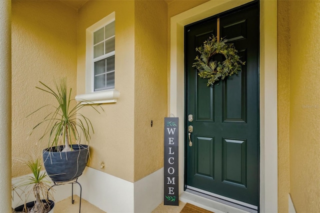 property entrance featuring stucco siding