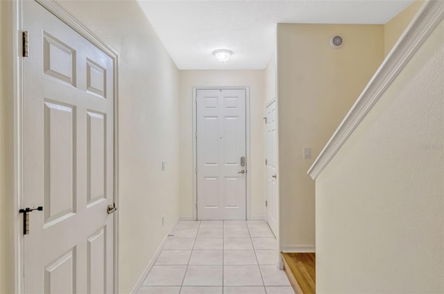 interior space featuring baseboards and light tile patterned flooring