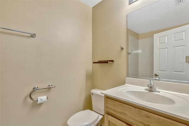 half bathroom with toilet and vanity