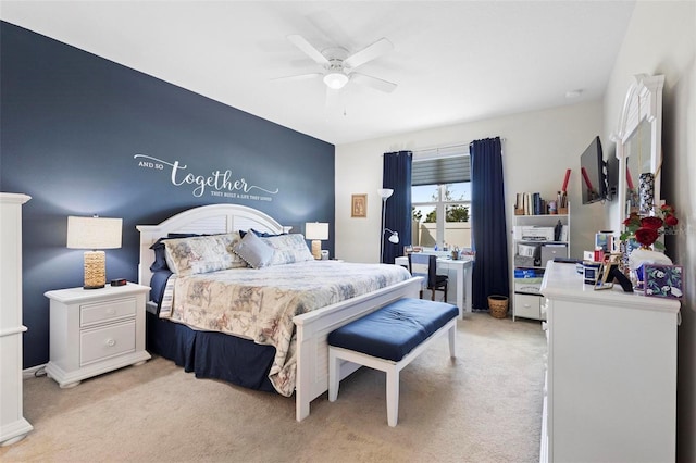bedroom with a ceiling fan and light carpet