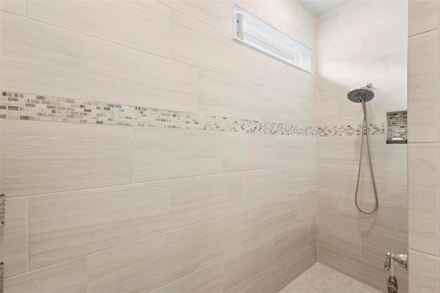 full bathroom featuring tiled shower