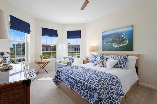 bedroom featuring carpet floors, a ceiling fan, and baseboards