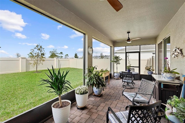 sunroom featuring a ceiling fan