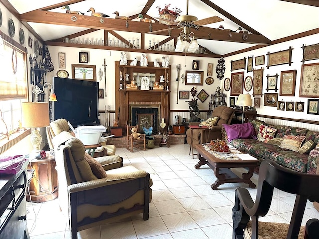 living room with vaulted ceiling with beams, a brick fireplace, and ceiling fan