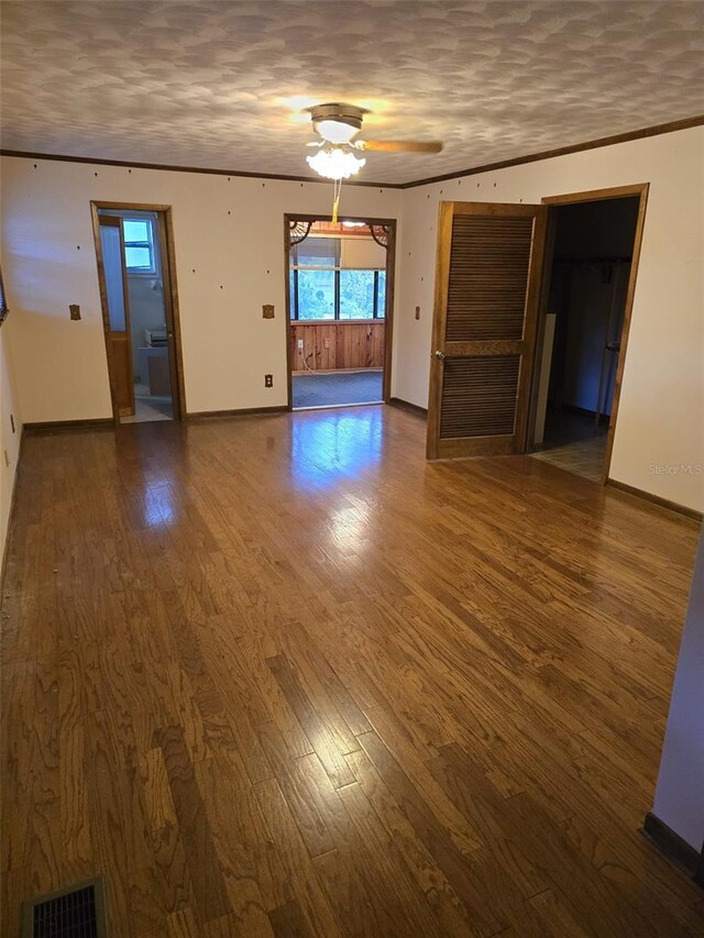 interior space featuring visible vents, baseboards, plenty of natural light, and wood finished floors