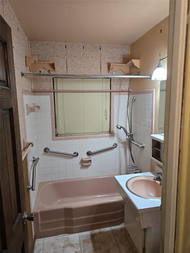 full bath with a sink, tile patterned flooring, and tub / shower combination