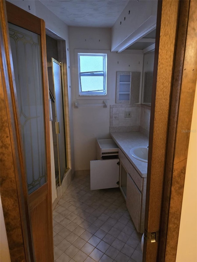 full bathroom with vanity, tile patterned flooring, and a stall shower
