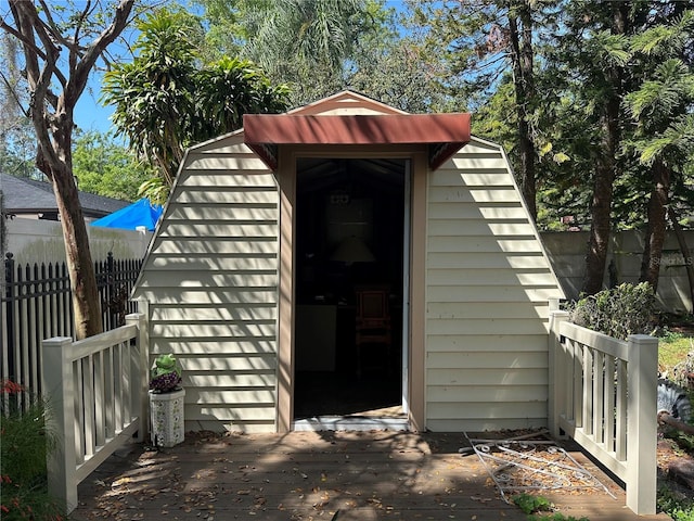 view of shed featuring fence