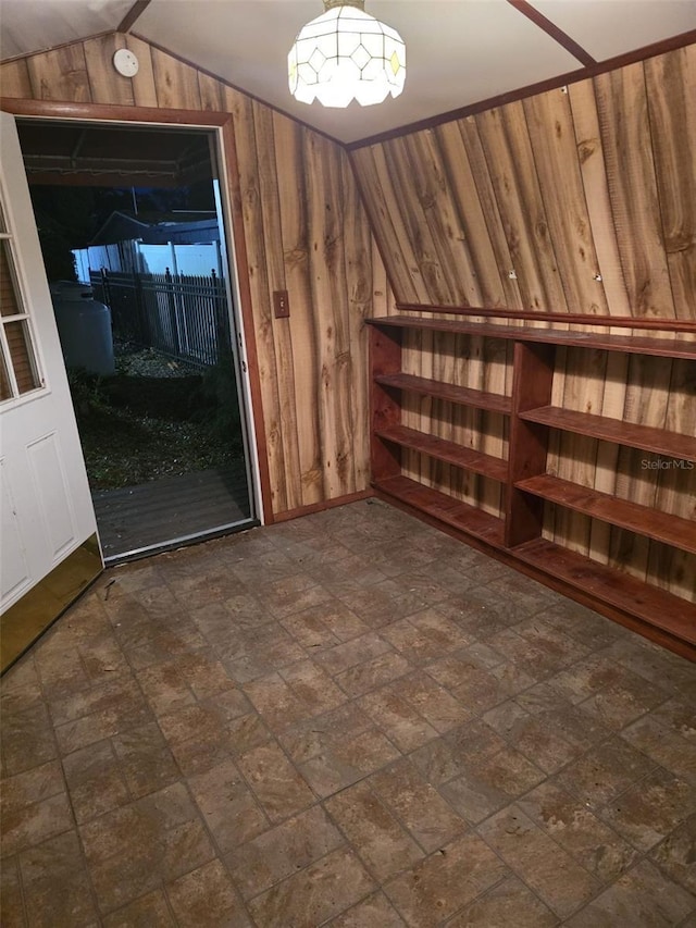 interior space featuring wood walls and vaulted ceiling
