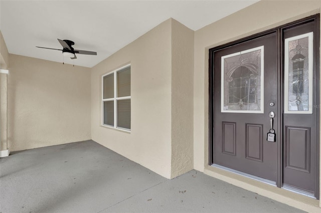 26807 Bull Run, Leesburg, FL 34748 - doorway to property featuring stucco siding, a ceiling fan, and a patio