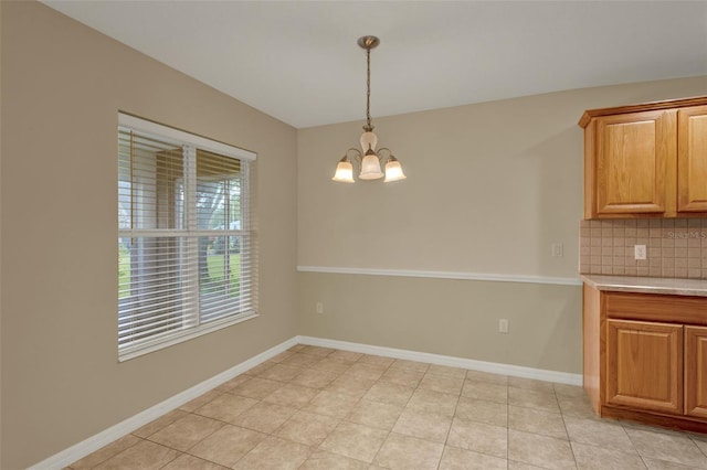 26807 Bull Run, Leesburg, FL 34748 - unfurnished dining area featuring a chandelier and baseboards