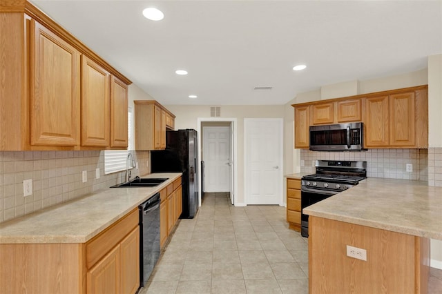 26807 Bull Run, Leesburg, FL 34748 - kitchen with appliances with stainless steel finishes, a peninsula, a sink, light countertops, and recessed lighting