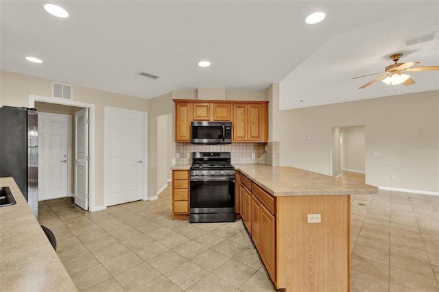 26807 Bull Run, Leesburg, FL 34748 - kitchen with stainless steel appliances, a peninsula, light countertops, light tile patterned floors, and a ceiling fan