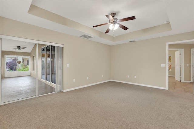 26807 Bull Run, Leesburg, FL 34748 - unfurnished room with a tray ceiling, a ceiling fan, carpet, and baseboards