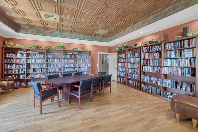 26807 Bull Run, Leesburg, FL 34748 - dining room featuring light wood finished floors, an ornate ceiling, a raised ceiling, and crown molding