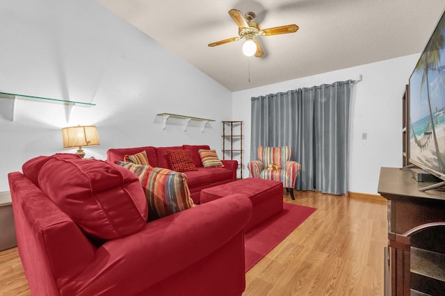 living room with a ceiling fan, wood finished floors, and lofted ceiling