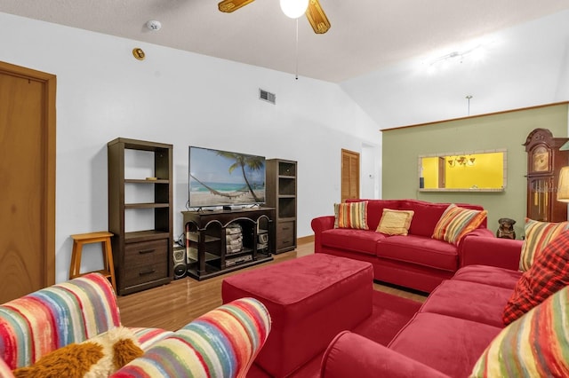 living room with ceiling fan, visible vents, wood finished floors, and lofted ceiling