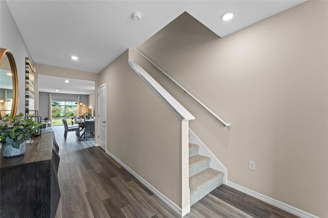 stairway featuring recessed lighting, baseboards, and wood finished floors
