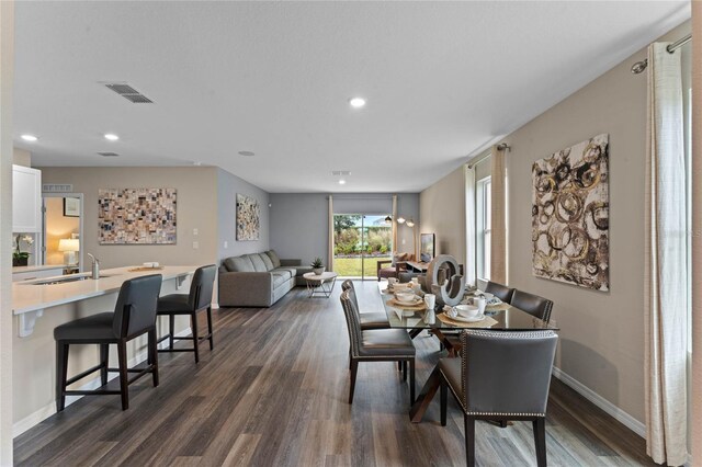 dining space with baseboards, visible vents, recessed lighting, and dark wood-type flooring