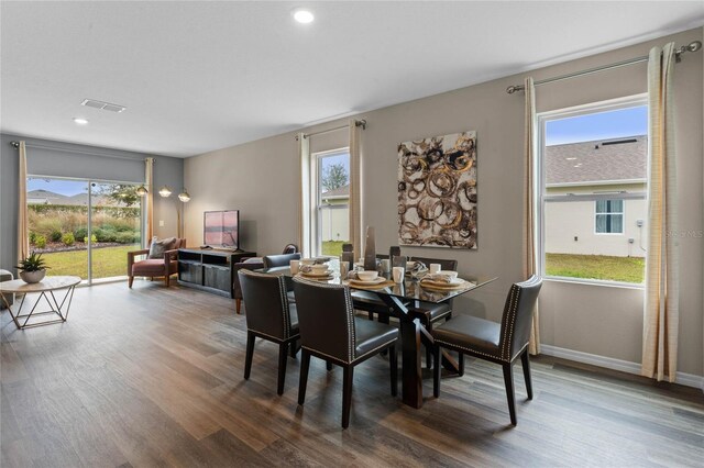 dining space featuring visible vents, wood finished floors, and a wealth of natural light