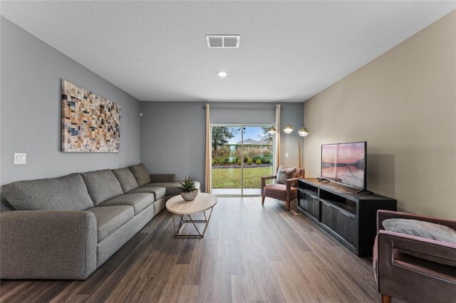 living area featuring recessed lighting, wood finished floors, and visible vents