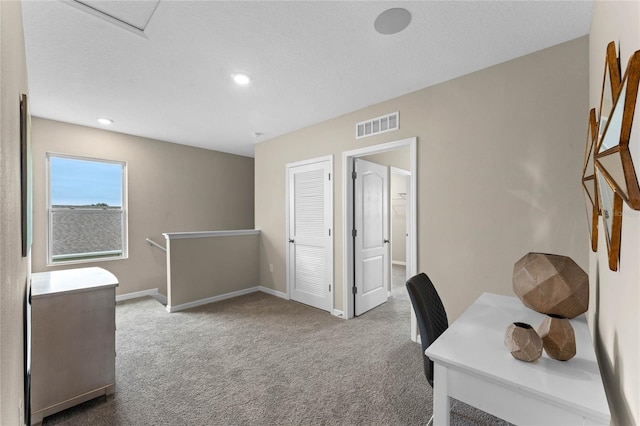 carpeted office space with visible vents, recessed lighting, and baseboards