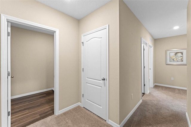 hall featuring baseboards, carpet flooring, and recessed lighting