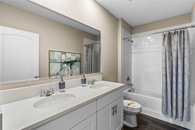 bathroom with double vanity, toilet, a sink, and shower / bath combo