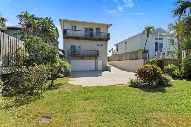 view of front facade with concrete driveway, fence, a balcony, and a garage