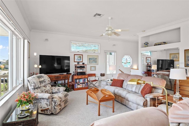 living area featuring crown molding, carpet, a ceiling fan, and visible vents