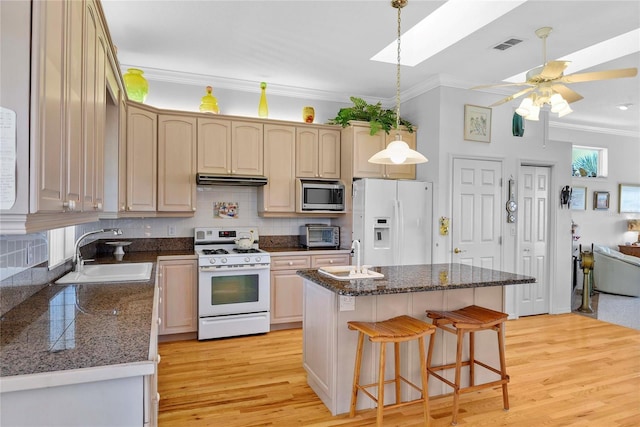 kitchen featuring crown molding, a sink, and white appliances
