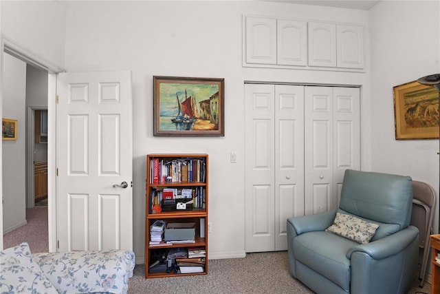sitting room with baseboards and carpet
