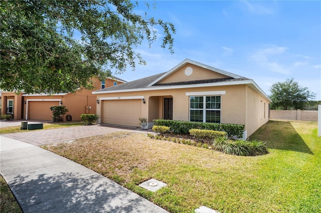3345 Reedy Glen Dr, Kissimmee, FL 34758 - single story home with driveway, a garage, fence, a front lawn, and stucco siding