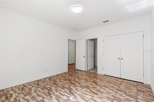3345 Reedy Glen Dr, Kissimmee, FL 34758 - unfurnished bedroom featuring baseboards, a closet, and visible vents