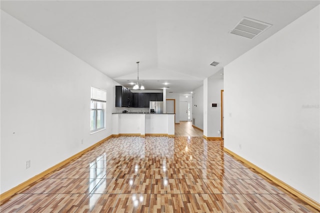 3345 Reedy Glen Dr, Kissimmee, FL 34758 - unfurnished living room featuring light tile patterned floors, baseboards, lofted ceiling, and visible vents
