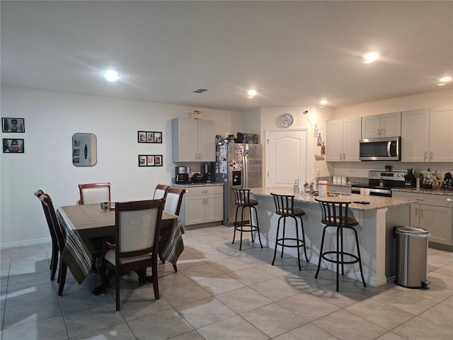 dining space with recessed lighting, baseboards, visible vents, and light tile patterned floors