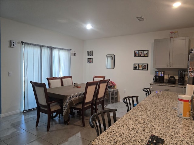 dining area featuring light tile patterned floors and visible vents