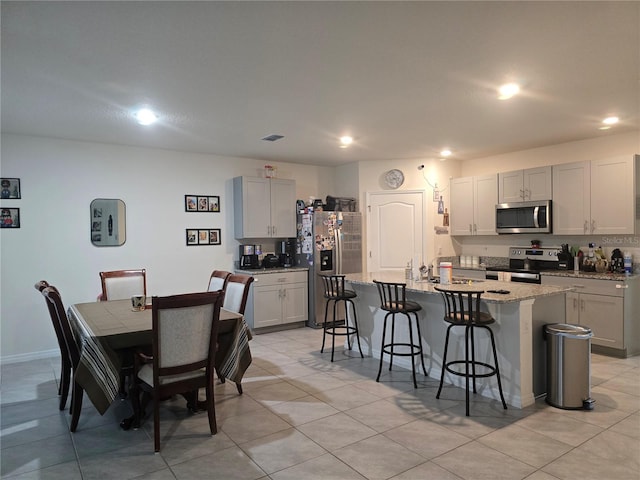 dining room featuring recessed lighting, visible vents, and light tile patterned floors
