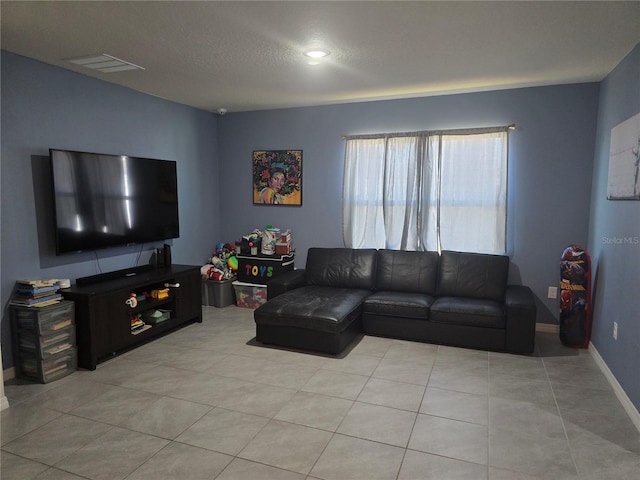 living room with visible vents and light tile patterned flooring