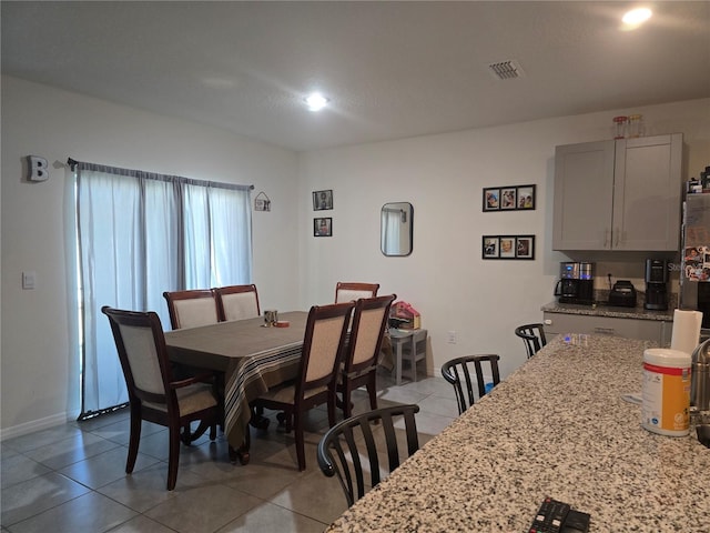 dining space with recessed lighting, baseboards, visible vents, and light tile patterned floors