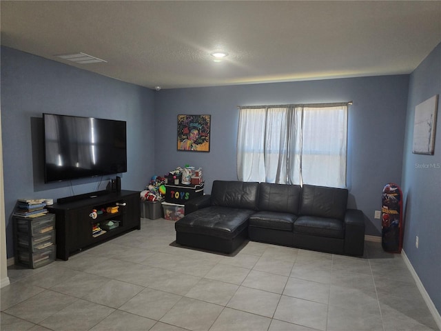 living room with baseboards, light tile patterned floors, and visible vents